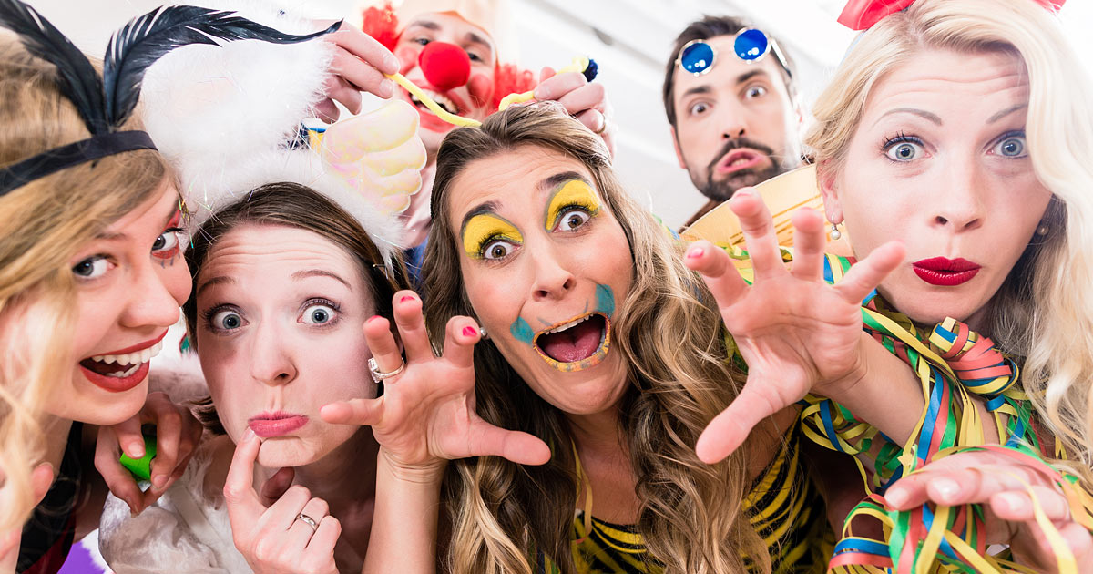 Gäste Posen an Karneval verkleidet vor dem Fotospiegel